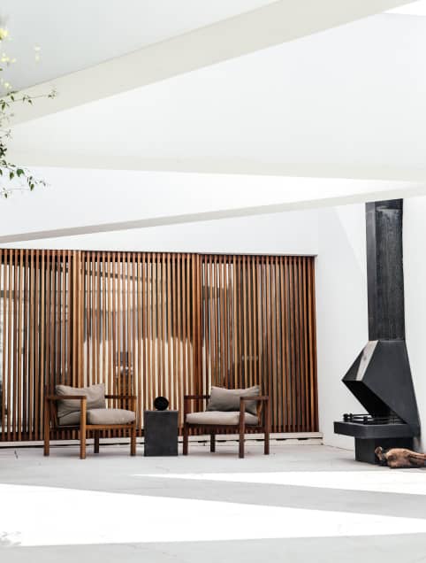 two chairs in room with a fireplace